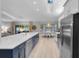 Kitchen with long island bar, stainless steel appliances, and natural light at 4791 S Peninsula Dr, Ponce Inlet, FL 32127