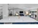 Spacious kitchen island with stone countertop and view of the living area at 4791 S Peninsula Dr, Ponce Inlet, FL 32127
