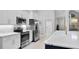 Modern kitchen with stainless steel appliances and view to living area at 4791 S Peninsula Dr, Ponce Inlet, FL 32127