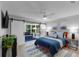 Inviting bedroom featuring sliding barn doors leading to a sunroom at 4791 S Peninsula Dr, Ponce Inlet, FL 32127