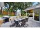 Charming backyard patio with outdoor seating, grill, and a small storage shed, perfect for entertaining guests at 4791 S Peninsula Dr, Ponce Inlet, FL 32127