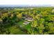 Stunning aerial view of home with pool, pergola, lush landscaping and surrounded by mature trees on a private lot at 4885 State Road 11, De Leon Springs, FL 32130