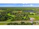 Expansive aerial shot showcases the property's landscape, highlighting its mature trees and serene country setting at 4885 State Road 11, De Leon Springs, FL 32130