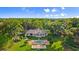 Gorgeous aerial view of the home's exterior, pool, and pristine landscaping at 4885 State Road 11, De Leon Springs, FL 32130