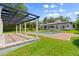 A pergola overlooks the pool and patio area that offers a great entertainment area with lush green grass at 4885 State Road 11, De Leon Springs, FL 32130