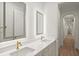 Elegant bathroom featuring double sinks, backlit mirrors, and gold fixtures at 4885 State Road 11, De Leon Springs, FL 32130