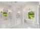 Luxury bathroom featuring marble floors, a tub, double vanities, and natural light at 4885 State Road 11, De Leon Springs, FL 32130