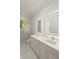 Modern bathroom featuring a double vanity with lighted mirrors, gold fixtures, and a glass shower at 4885 State Road 11, De Leon Springs, FL 32130