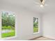 Bright bedroom featuring natural light, views of the lawn, and a ceiling fan at 4885 State Road 11, De Leon Springs, FL 32130