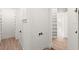 Bright closet with shelving, drawers, wood-look flooring, and white doors with dark hardware at 4885 State Road 11, De Leon Springs, FL 32130