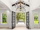 Grand entryway featuring ornate iron doors opening to a lush, green landscape at 4885 State Road 11, De Leon Springs, FL 32130