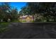 This well-maintained single-story home has a fountain, a tile roof, and a well-manicured lawn at 4885 State Road 11, De Leon Springs, FL 32130