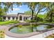 Stunning home featuring a captivating water feature, lush lawns, and impeccable curb appeal at 4885 State Road 11, De Leon Springs, FL 32130