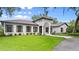Striking house with pristine lawn, neatly trimmed shrubs, and elegant architecture at 4885 State Road 11, De Leon Springs, FL 32130