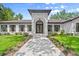 Stately home with manicured landscaping, a walkway, and a grand entrance at 4885 State Road 11, De Leon Springs, FL 32130