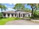 Immaculate residence features a tile roof, manicured lawn, and beautiful front yard at 4885 State Road 11, De Leon Springs, FL 32130