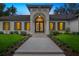 The beautifully landscaped, single-story home features a grand entrance and meticulous landscaping at 4885 State Road 11, De Leon Springs, FL 32130