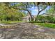 Elegant home boasts lush landscaping and a stately driveway leading to the entrance at 4885 State Road 11, De Leon Springs, FL 32130