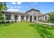 Charming home boasting a lush green lawn, symmetrical landscaping, and a welcoming facade at 4885 State Road 11, De Leon Springs, FL 32130