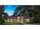 This well-maintained single-story home has a fountain, a tile roof, and a well-manicured lawn at 4885 State Road 11, De Leon Springs, FL 32130
