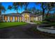 A stately single-story home is complemented by manicured landscaping and a tranquil water feature at 4885 State Road 11, De Leon Springs, FL 32130