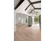 Bright foyer with a decorative iron chandelier, wood-look flooring, and wrought iron entry doors at 4885 State Road 11, De Leon Springs, FL 32130