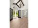 Elegant foyer featuring an iron chandelier, wood-look flooring, and decorative iron entry doors at 4885 State Road 11, De Leon Springs, FL 32130