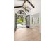 Elegant foyer featuring an iron chandelier, wood-look flooring, and decorative iron entry doors at 4885 State Road 11, De Leon Springs, FL 32130