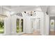 Elegant foyer with arched entryway, hardwood floors, and wrought iron double doors at 4885 State Road 11, De Leon Springs, FL 32130