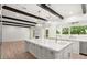 Spacious kitchen with large island, marble countertops, stainless steel appliances, and wood beam accents at 4885 State Road 11, De Leon Springs, FL 32130