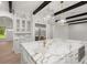 Elegant kitchen with a large marble island, gold fixtures, and stainless steel appliances at 4885 State Road 11, De Leon Springs, FL 32130