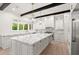 Modern kitchen featuring a large island, marble countertops, and stainless steel appliances at 4885 State Road 11, De Leon Springs, FL 32130
