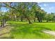 Grassy land with trees and black fence at 4885 State Road 11, De Leon Springs, FL 32130