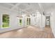Bright and airy living room with coffered ceilings, hardwood floors, and beautiful chandeliers at 4885 State Road 11, De Leon Springs, FL 32130