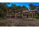 View of barn with stalls showcasing its functional design for horses or other animals. Equipped with lights at 4885 State Road 11, De Leon Springs, FL 32130
