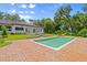 The pool is surrounded by lush green landscaping and brick flooring giving this backyard a luxurious feel at 4885 State Road 11, De Leon Springs, FL 32130