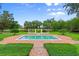 Refreshing pool with brick deck and verdant landscaping offers a serene outdoor retreat at 4885 State Road 11, De Leon Springs, FL 32130