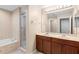 This bathroom features a double vanity, soaking tub and a glass enclosed shower at 5060 Cypress Branch Pt, Oviedo, FL 32765