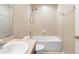 This bathroom features a white vanity, tile floors and a tub with shower at 5060 Cypress Branch Pt, Oviedo, FL 32765