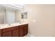 Bathroom featuring double sinks, granite countertops, and a large mirror at 5060 Cypress Branch Pt, Oviedo, FL 32765