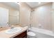 This bathroom features a white vanity, tile floors and a tub with shower at 5060 Cypress Branch Pt, Oviedo, FL 32765