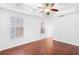 Bright bedroom with hardwood floors, ceiling fan and two large windows at 5060 Cypress Branch Pt, Oviedo, FL 32765