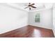 Cozy bedroom features a ceiling fan, tray ceiling, hardwood floors, and plenty of natural light at 5060 Cypress Branch Pt, Oviedo, FL 32765