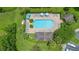 The image shows an aerial view of the community pool with lots of lounge chairs and tables at 5060 Cypress Branch Pt, Oviedo, FL 32765
