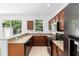 Updated kitchen boasts granite counters, wood cabinets, and stainless steel appliances at 5060 Cypress Branch Pt, Oviedo, FL 32765