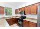 Charming kitchen with black appliances, granite countertops, and ample natural light at 5060 Cypress Branch Pt, Oviedo, FL 32765