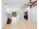 Bright, open-concept living room featuring tile floors, modern lighting, and access to the kitchen at 5060 Cypress Branch Pt, Oviedo, FL 32765