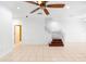 Spacious living room featuring neutral tile flooring, ceiling fan, and a staircase to the second floor at 5060 Cypress Branch Pt, Oviedo, FL 32765