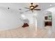 Spacious living room featuring tile flooring, modern ceiling fan, staircase, and seamless flow to the kitchen at 5060 Cypress Branch Pt, Oviedo, FL 32765