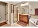 Bathroom with a glass-enclosed shower, vanity with granite countertop, and neutral tile at 508 Morgan Wood Dr, Deland, FL 32724